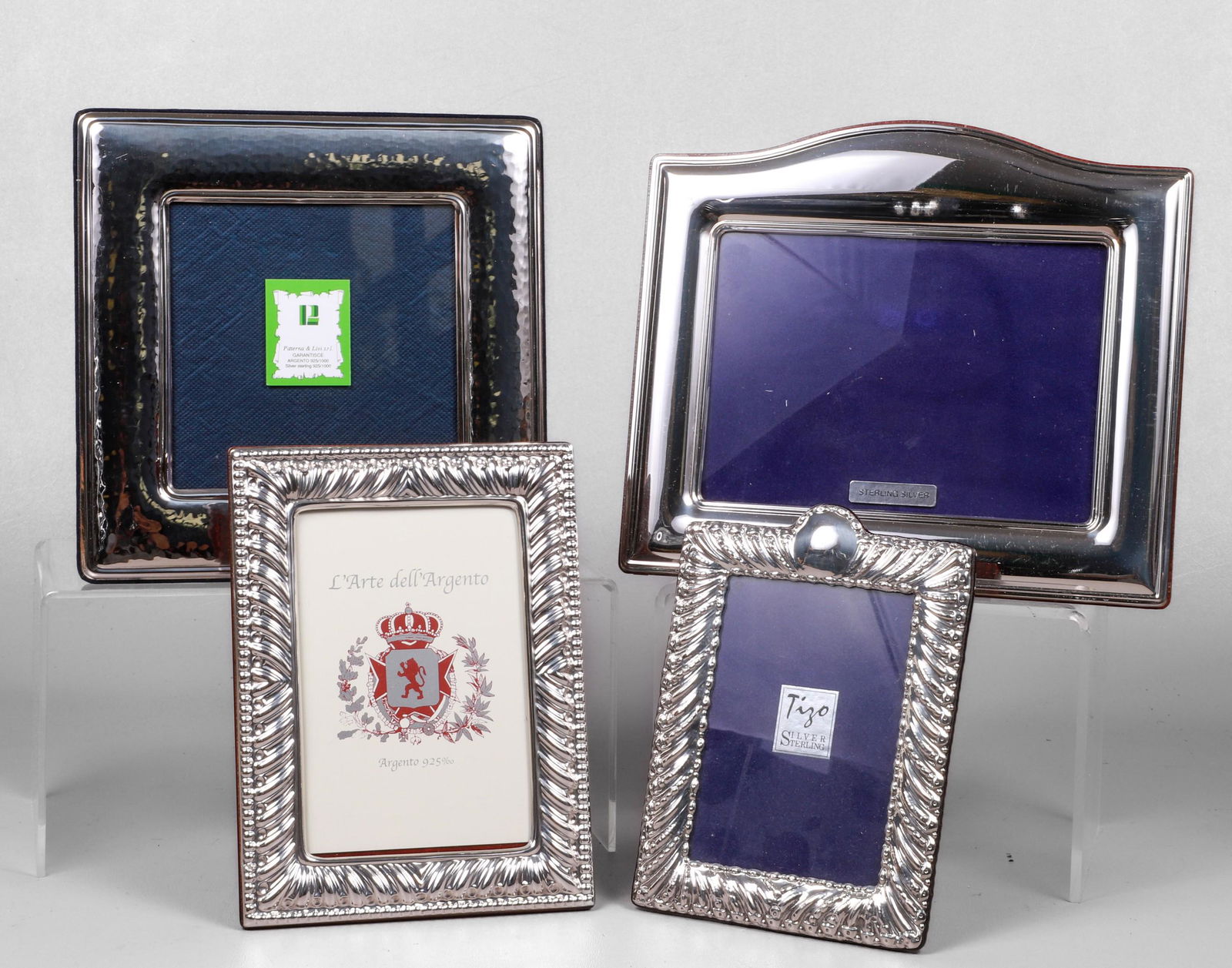 (4) Sterling Mounted Picture Frames: (4) Sterling mounted picture frames to include Paterna & Livi hammered sterling frame, 5"x5" photo, 8-1/4" square, Tizo Italian repousse frame with blank crest, 3-3/8"x4-3/4" photo, 7-1/4"Hx5-1/4"W, L