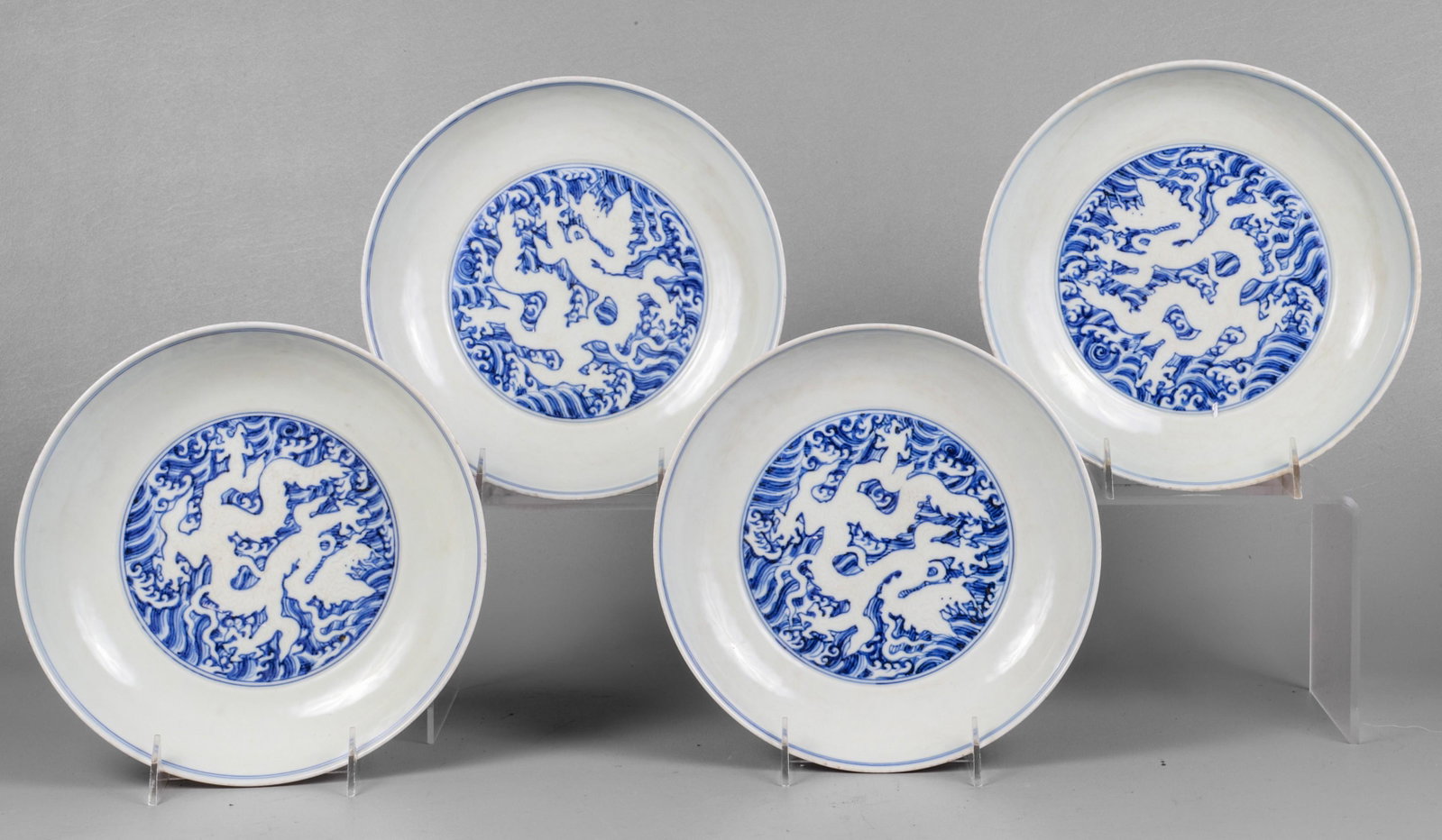 (4) Chinese Blue & White Porcelain Shallow Bowls: (4) Chinese blue and white porcelain shallow bowls, dragon decoration, 6-character mark to base, 8-3/4" dia x 1-7/8" h