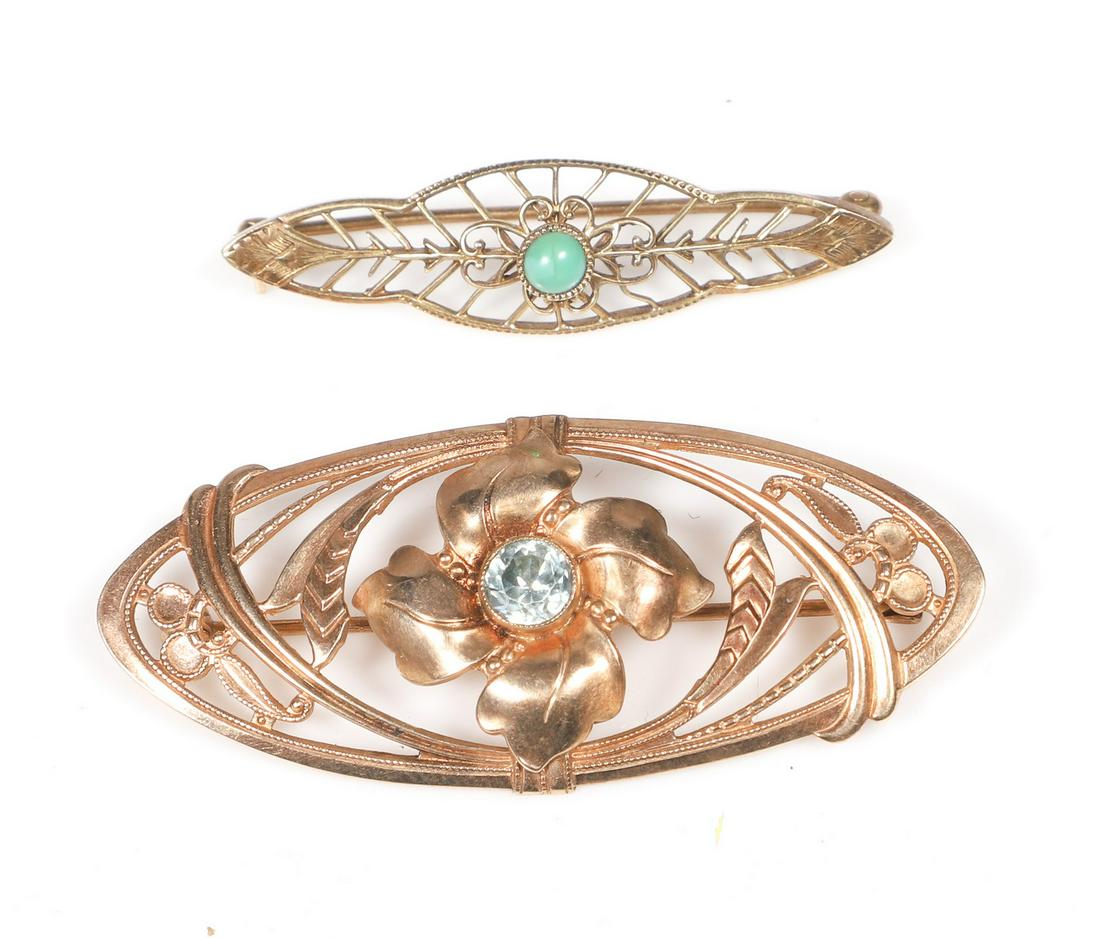 (2) Gold Art Nouveau Brooches: (2) Gold Art Nouveau brooches to include 10K Art Nouveau blue topaz brooch, pierced floral decoration, stamped 10K, 2"L, and 14K pierced brooch with green cabochon stone at center, 1-1/2"L, 4.1 DWT