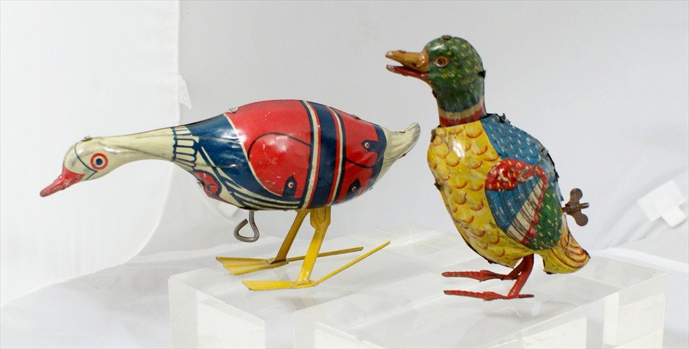 Two Tin Lithograph Wind Up Ducks, One tin litho du: Two Tin Lithograph Wind Up Ducks, One tin litho duck, 6" h, scratches, not working, the other with a red and blue jacket, Pat Pending 1924, 9" long, bent foot, minor scratches, working.