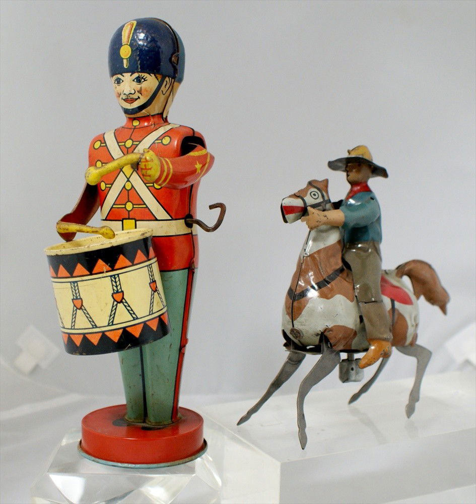 Two Tin Wind Up Toy Toys, J. Chein Tin Toy Wind Up: Two Tin Wind Up Toy Toys, J. Chein Tin Toy Wind Up Drummer, 8-3/4" h, working, and Unmarked Cowboy on Horse, 5" h, good works by no independent movement.