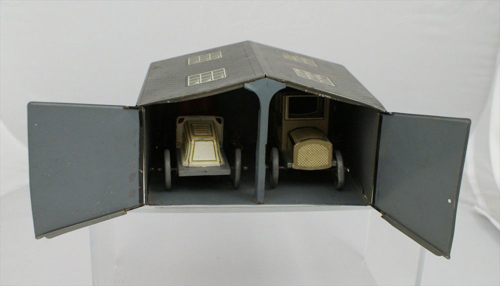 "BW" Bing marked Tin Garage and Two Wind Up Cars,: "BW" Bing marked Tin Garage and Two Wind Up Cars, marked "Germany", Opening doors. One a sedan and one a touring car, mechanisms turn but do not propel on their own, 8" x 6-1/2" x 5-1/4" h.