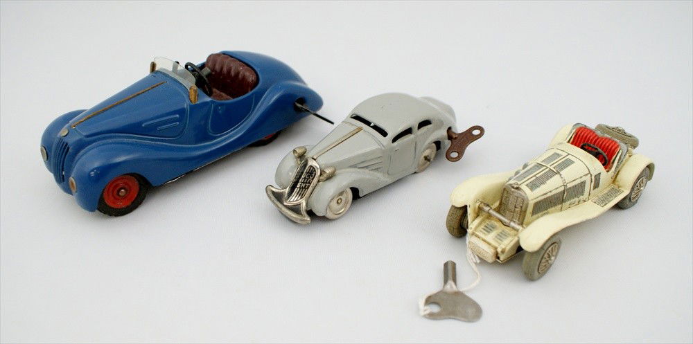 Three Schuco Wind Up Cars, Convertible is blue, 5-: Three Schuco Wind Up Cars, Convertible is blue, 5-1/2" l, working, and Mirako 1001, grey, Made in US Zone Germany, 4-1/2" l, working, and Micro Racer Mercedes SSK, 1043/1, Made in Western Germany, 4-1