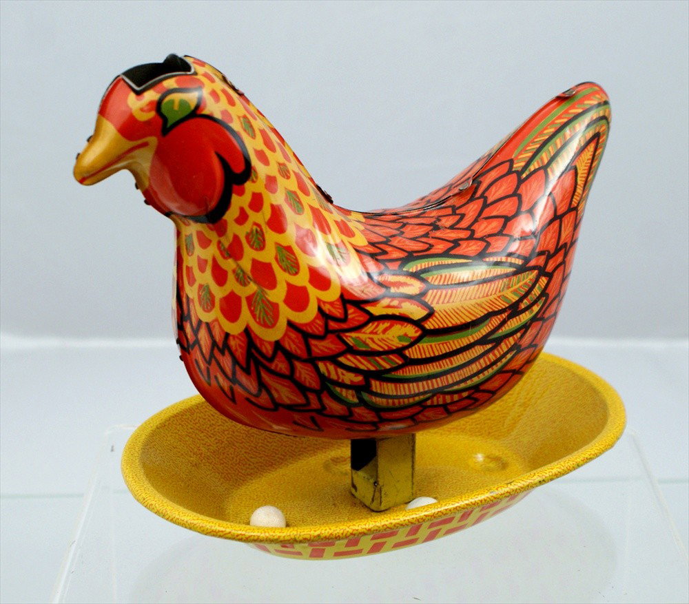 Tin Chromolithograph Hen Laying Eggs, press down a: Tin Chromolithograph Hen Laying Eggs, press down and she lays eggs, 6-1/2" h.