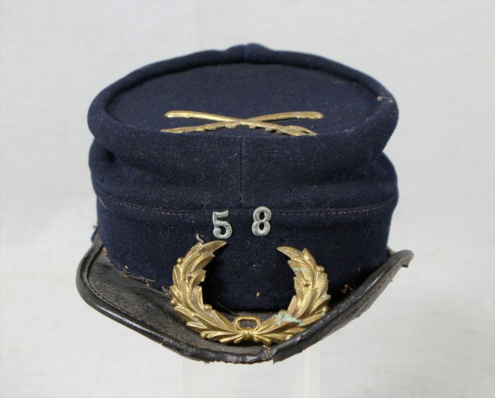 Navy Blue Union Civil War Cap, with brass crossed: Navy Blue Union Civil War Cap, with brass crossed swords on top, 58 on front, brass leaves detached, stamped Williamson and Foster, Harrisburg and Lancaster in interior,10-1/2" l, 2" h.