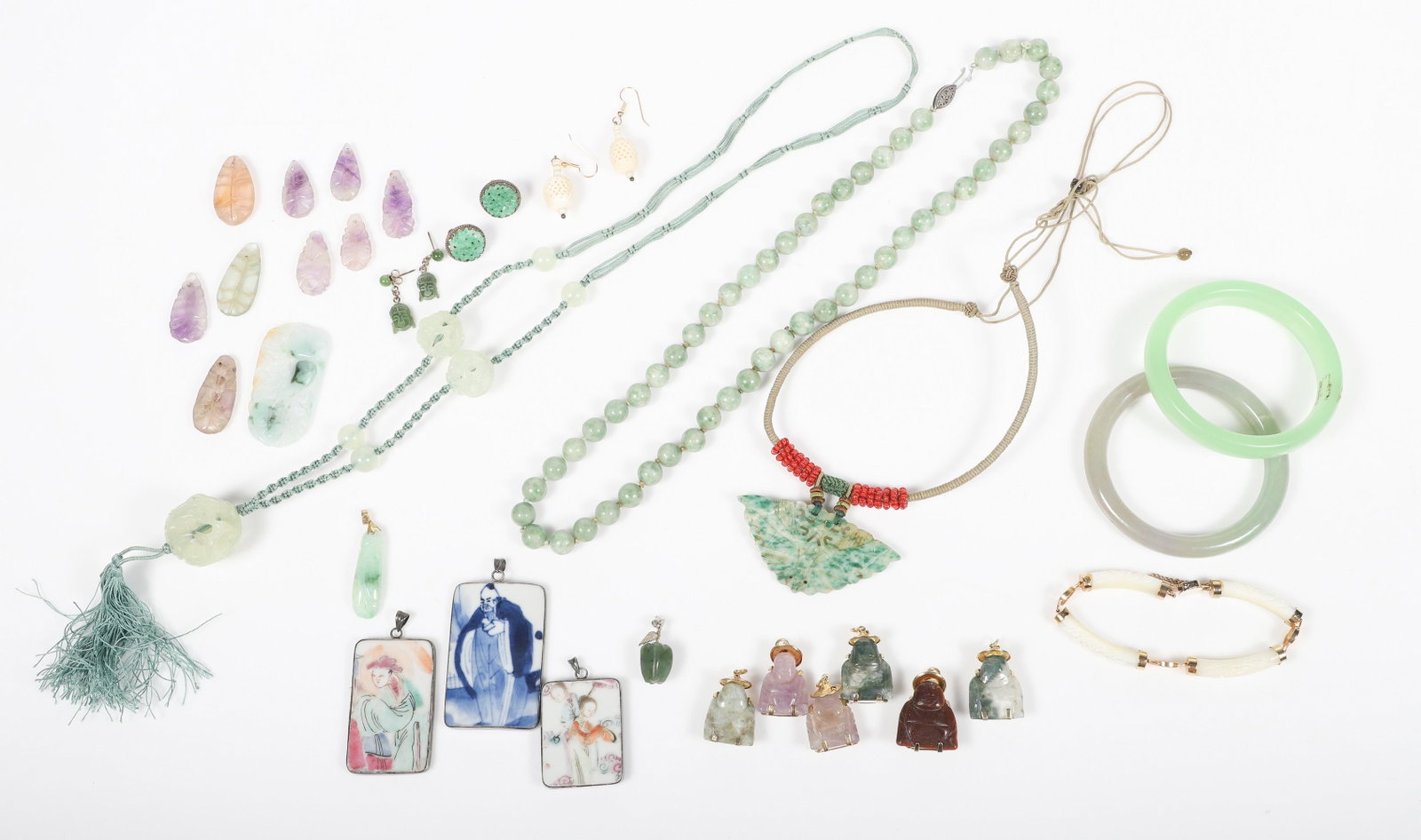 Asian Jewelry Group: Asian jewelry group to include (3) framed porcelain pottery fragments as pendants, (2) jade style bangles, green stone bead necklace, pierced moth form stone pendant on cord, pierced jade style beads 