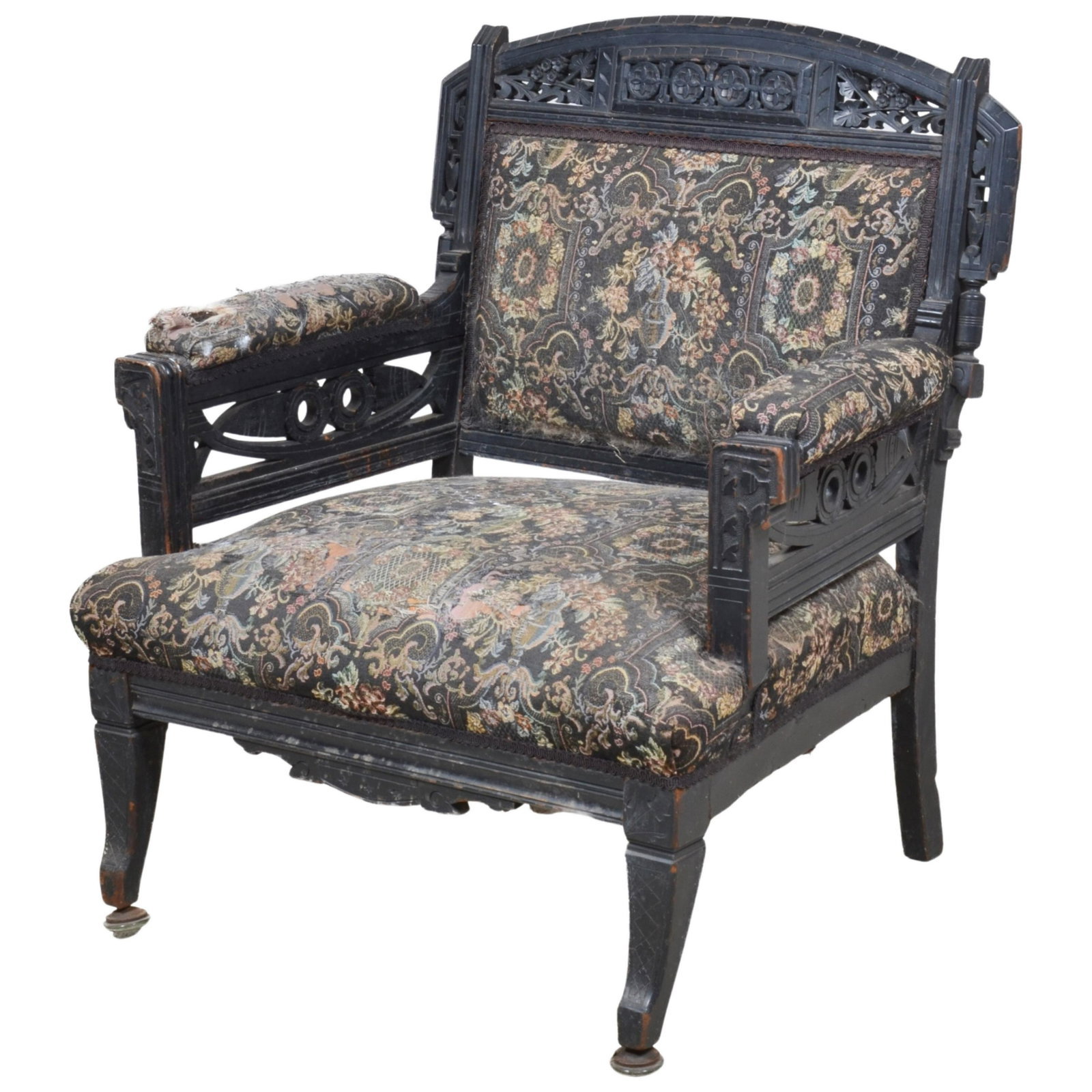 An Eastlake fret carved ebonized armchair: An Eastlake fret carved ebonized armchair, fourth quarter 19th century, height 34 1/4in; width 31 1/4in; depth of seat 22in
