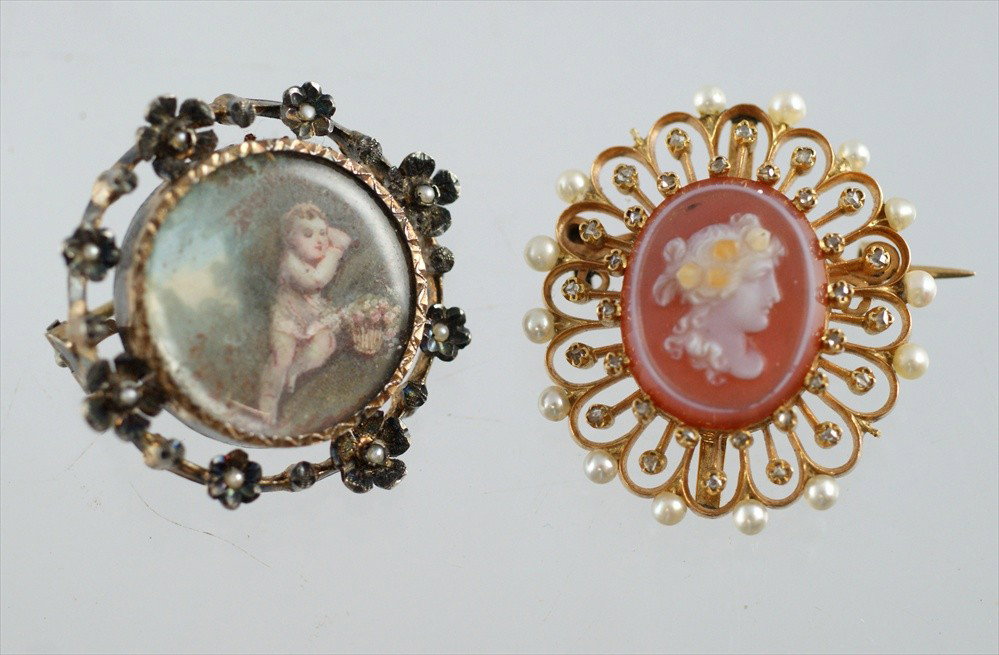 Unmarked YG diamond and pearl pin set with oval ca: Unmarked YG diamond and pearl pin set with oval carved stone cameo, 1 1/4" h, along with a round gilt silver pin set with HP ivory panel depicting a cherb in a garden, 1 1/8" d