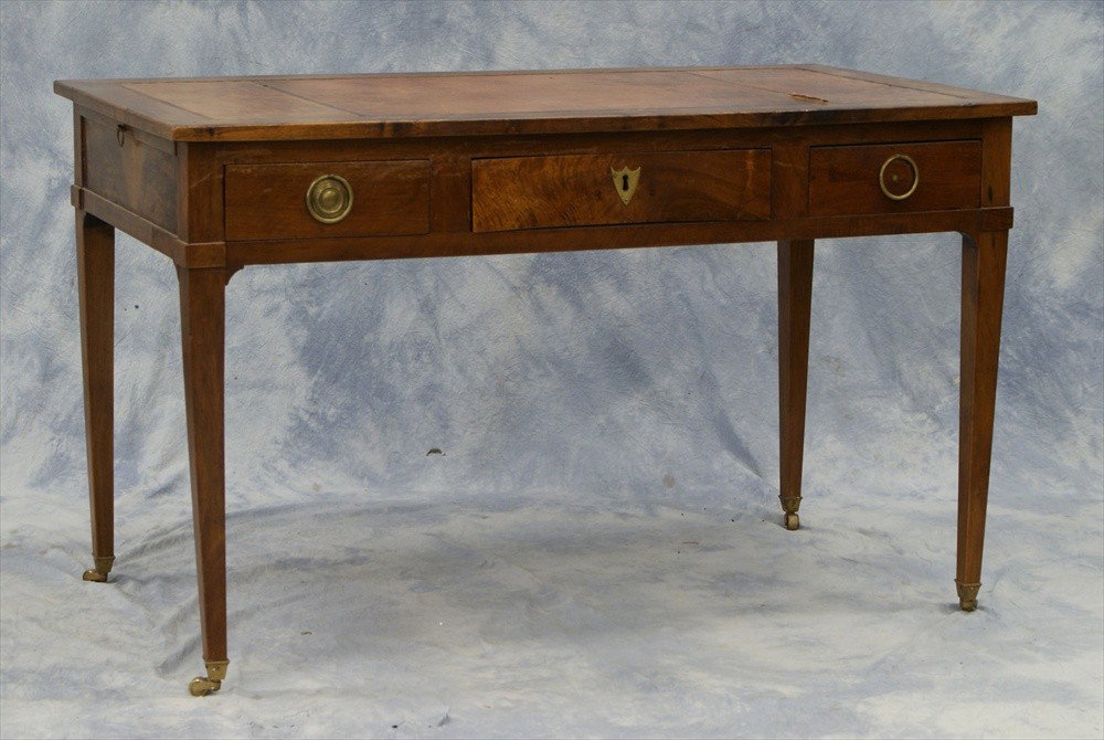 Georgian Hepplewhite leather top writing desk, ear: Georgian Hepplewhite leather top writing desk, early 19th C, with side extensions, 3 drawers, on brass wheels, 50-1/2" w, 27-1/2" d, 30-1/2" h, minor leather rip on top, missing brass on right drawer.