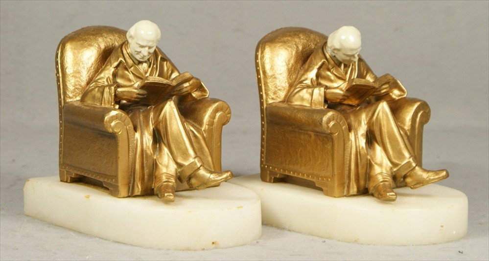 Pr man reading bookends by J Ruhl and J B Hirsch, : Pr man reading bookends by J Ruhl and J B Hirsch, patinated white metal, some flakes on finish, on black stone base, ivorine heads, 6" l, 4 1/2" h