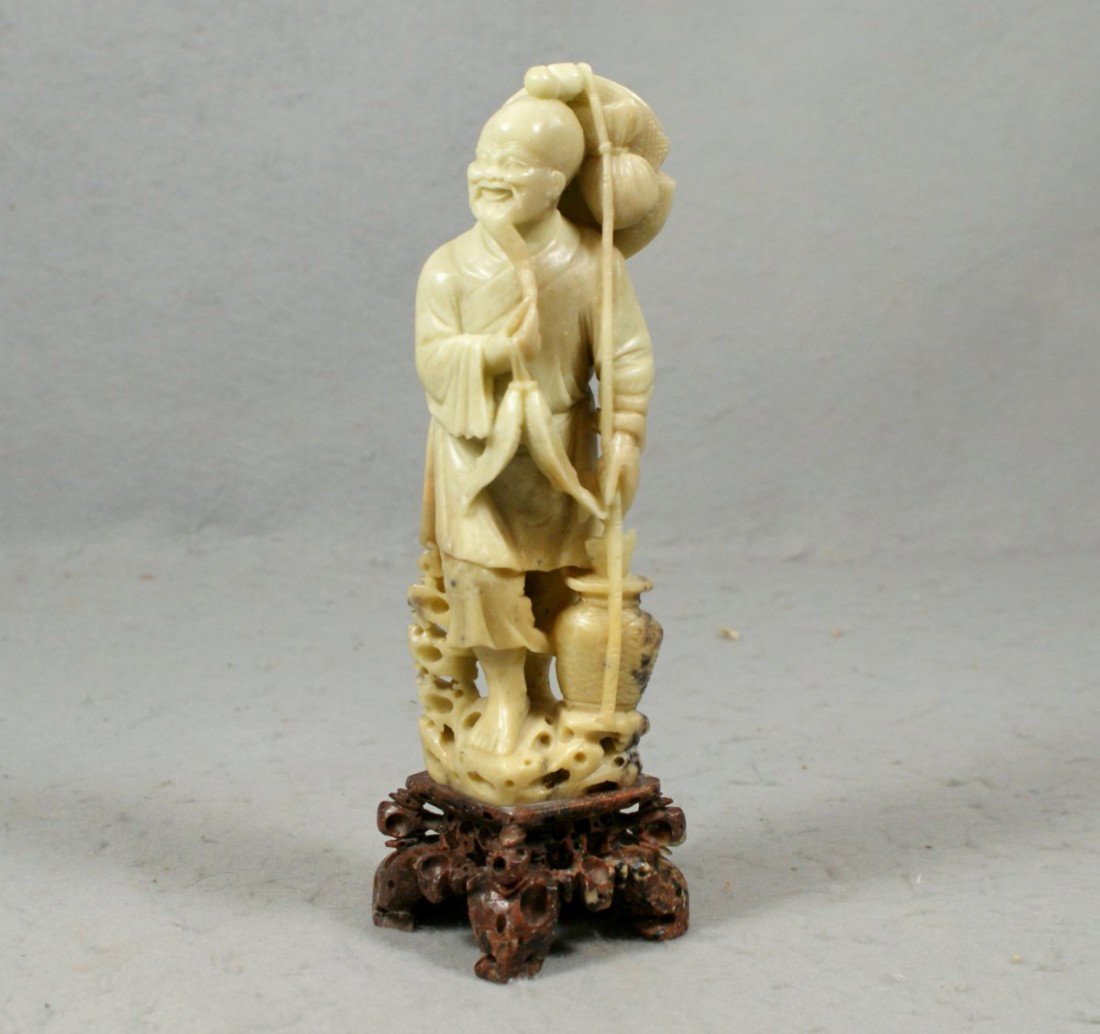 Carved soapstone figure of a fisherman, 10" high: Carved soapstone figure of a fisherman, 10" high