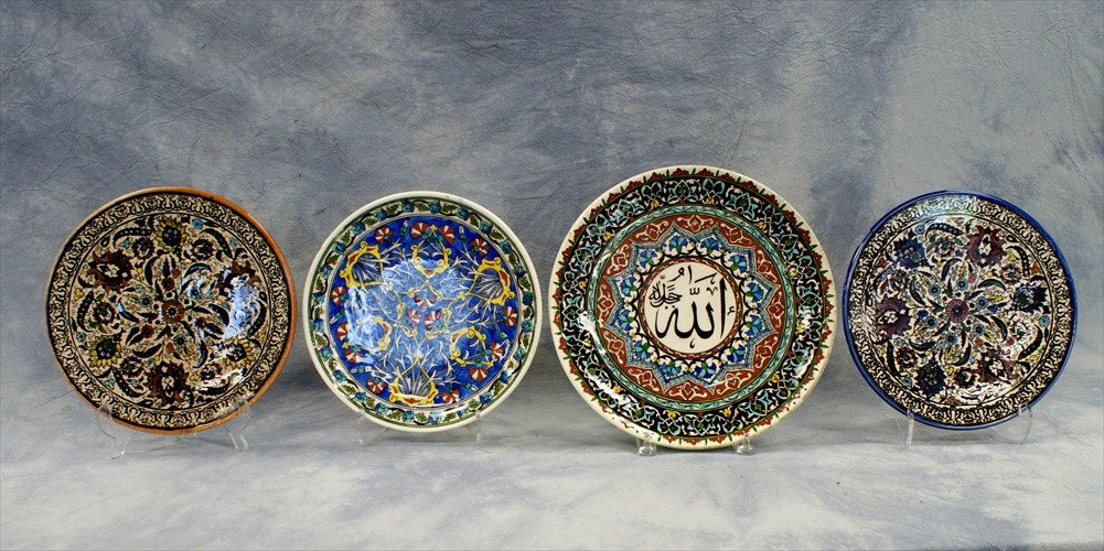 (4) Assorted Persian pottery plates, 20th C, lar: (4) Assorted Persian pottery plates, 20th C, largest 12 1/2" dia
