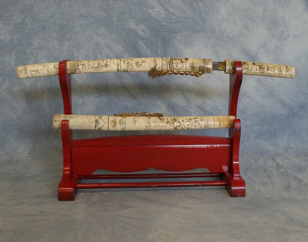 (2) Japanese carved bone samurai sword and knife: (2) Japanese carved bone samurai sword and knife, together with a red lacquered stand, 20th C