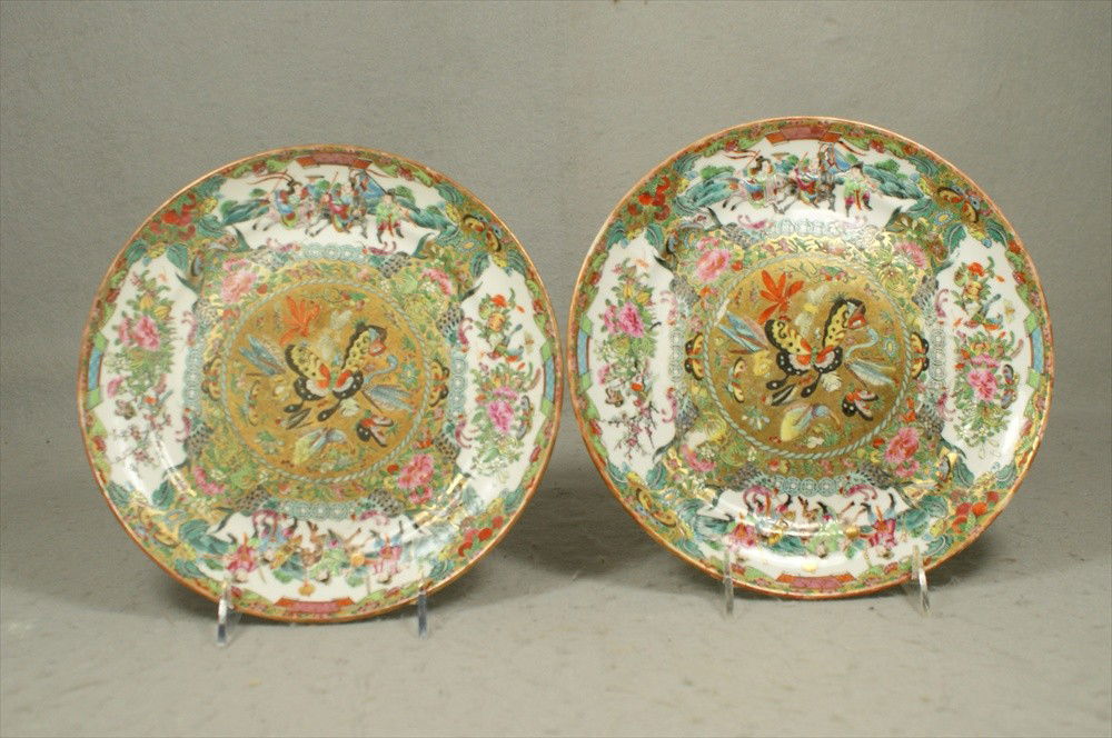 Pr Famille Rose enameled plates, a rare pattern,: Pr Famille Rose enameled plates, a rare pattern, with Mandarin scenes and Famille Rose cavettes, with the central medallion gilded and enameled with exotic butterflies, birds, insects etc, 9 1/2"