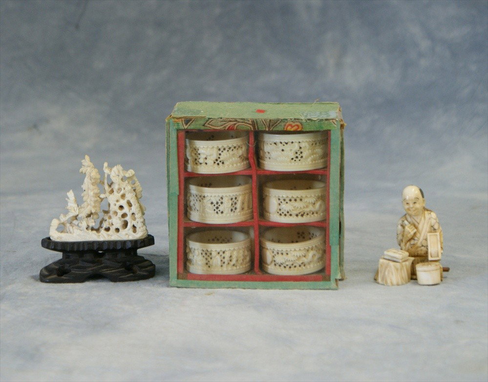 Carved ivory box with 6 pierced Chinese napkin r: Carved ivory box with 6 pierced Chinese napkin rings, a small Japanese figure with losses, and a pierced carving as is 3"h, 19th century