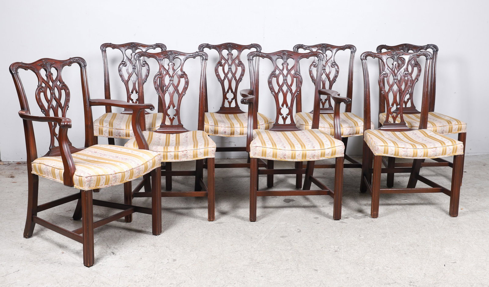 (8) Chippendale style carved mahogany dining chairs: (8) Chippendale style carved mahogany dining chairs, pierced carved back, upholstered seat, 37"h x 22"w x 20"d, Mid 20th c, overall wear due to use and age, 1 chair back with unprofessionally repaired