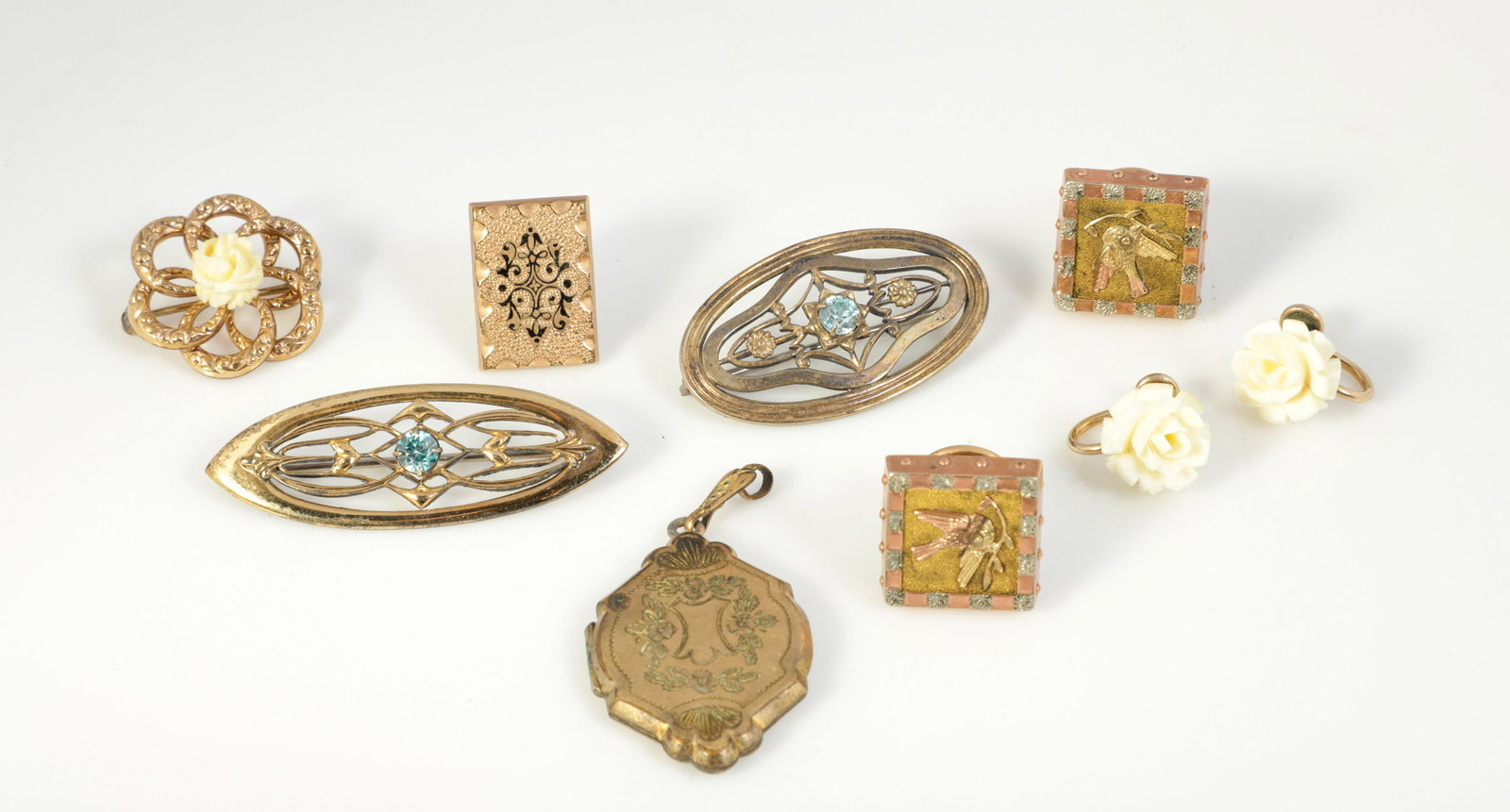 (9) Gold Filled Articles: (9) Gold filled articles to include victorian gold filled locket pendant, gold filled brooch with carved bone flower center and matched earring pair, victorian tri-color gold filled cufflinks, single 