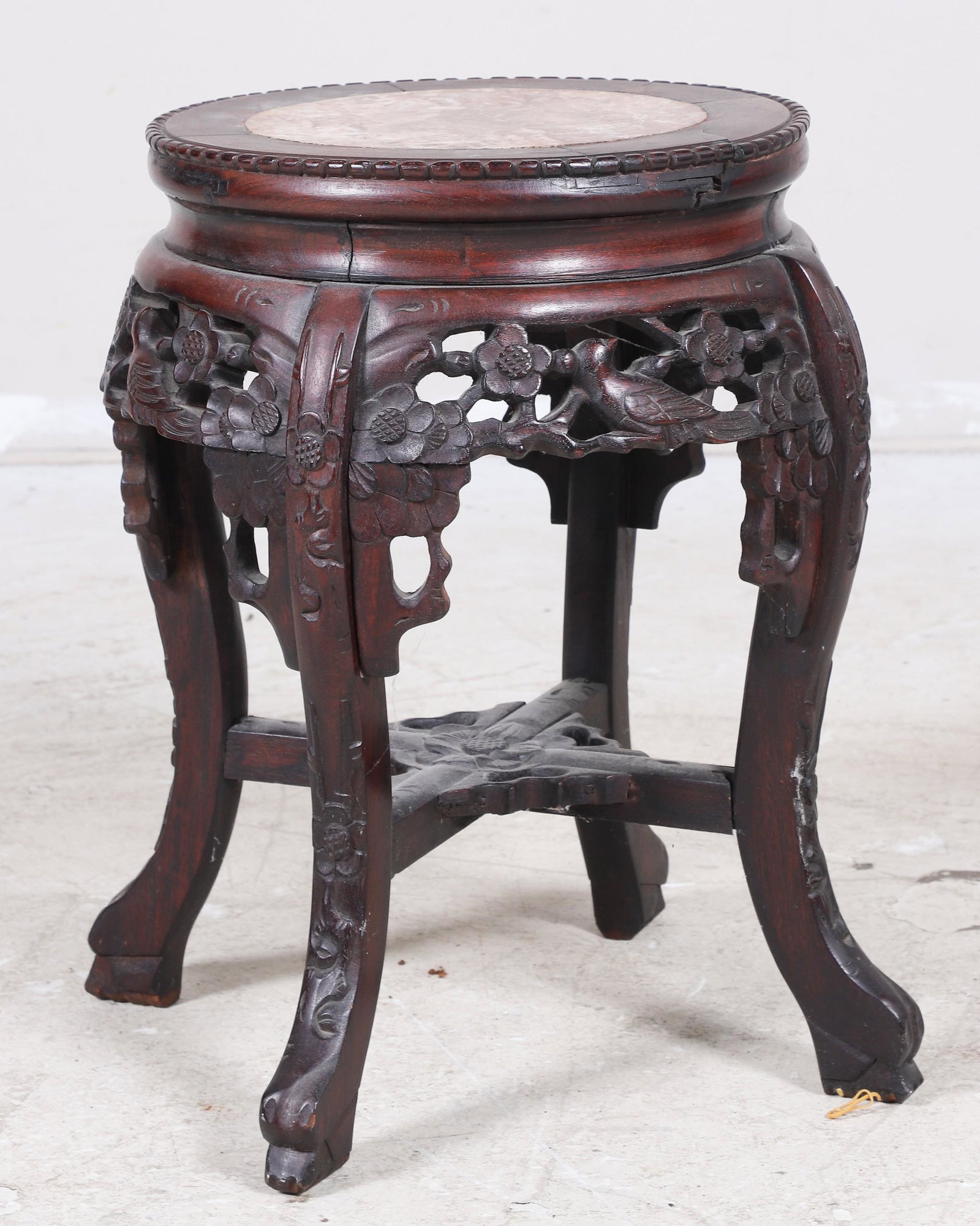 Chinese pierced carved marbletop pedestal: Chinese pierced carved marbletop pedestal, inset marble, pierced carved skirt with birds and flowers, 18"h x 12-1/2"diameter