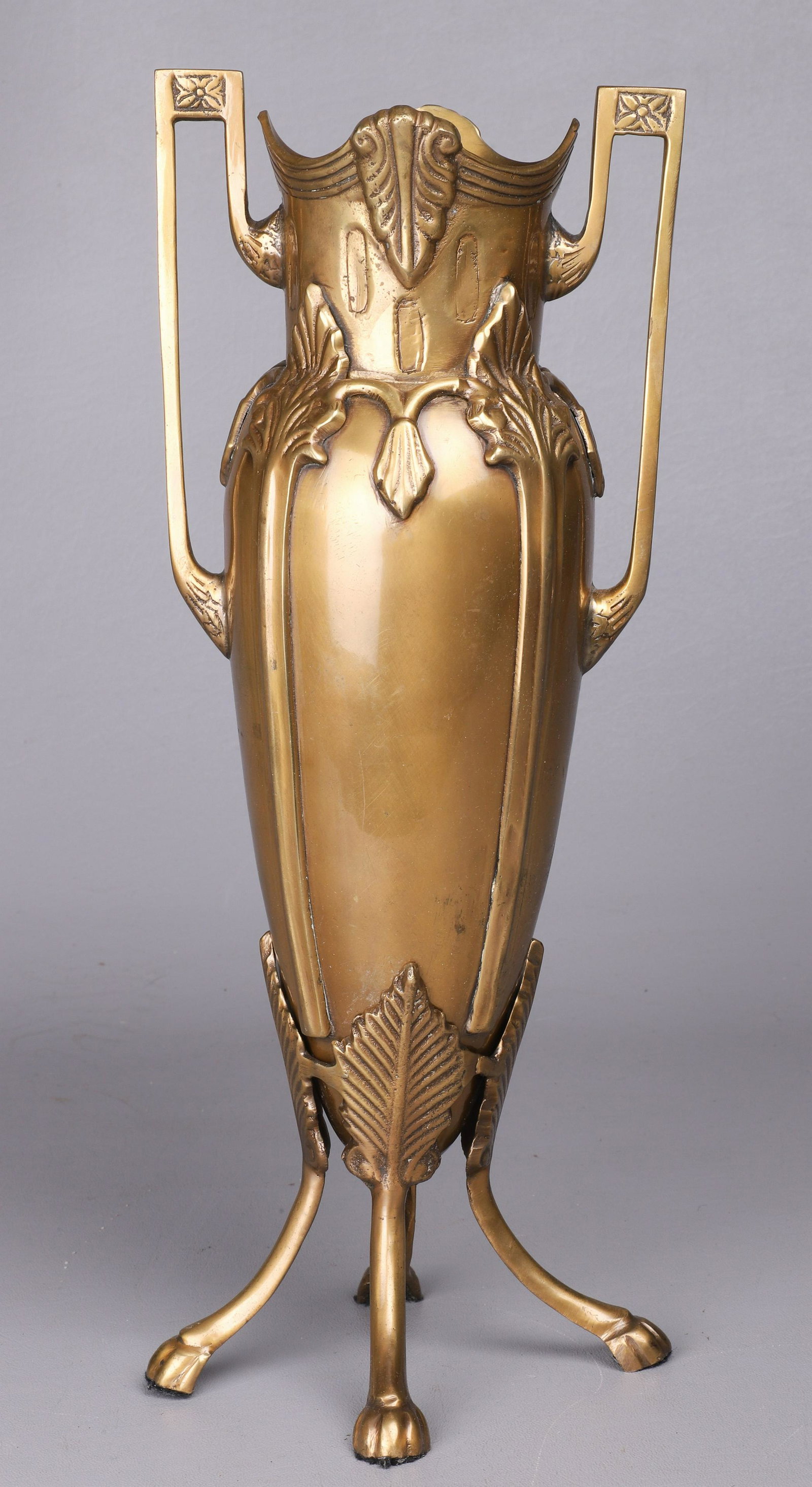 Gilt Bronze Nouveau Vase in Stand: Gilt bronze Nouveau vase in stand, double handle at sides, with applied leaf and embossed decoration, fitted in leaf and paw foot stand, 14-1/2"H, unsigned