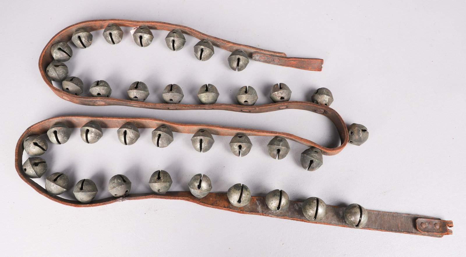 Strap of (36) Sleigh Bells: Leather strap with (36) sleigh bells, bells 1-1/4" dia, strap approx 78" l