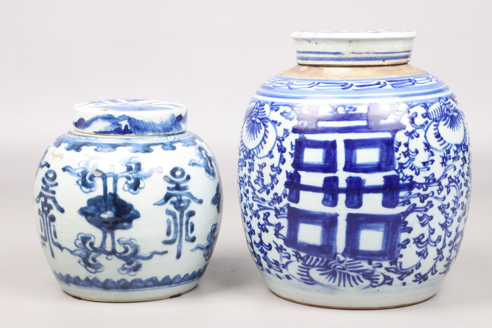 (2) Chinese Blue & White Porcelain Covered Jars: (2) Chinese blue & white porcelain covered jars, c/o unmarked Double Happiness pattern ( 9-1/2" h), double blue ring mark to base (6-3/4" h)