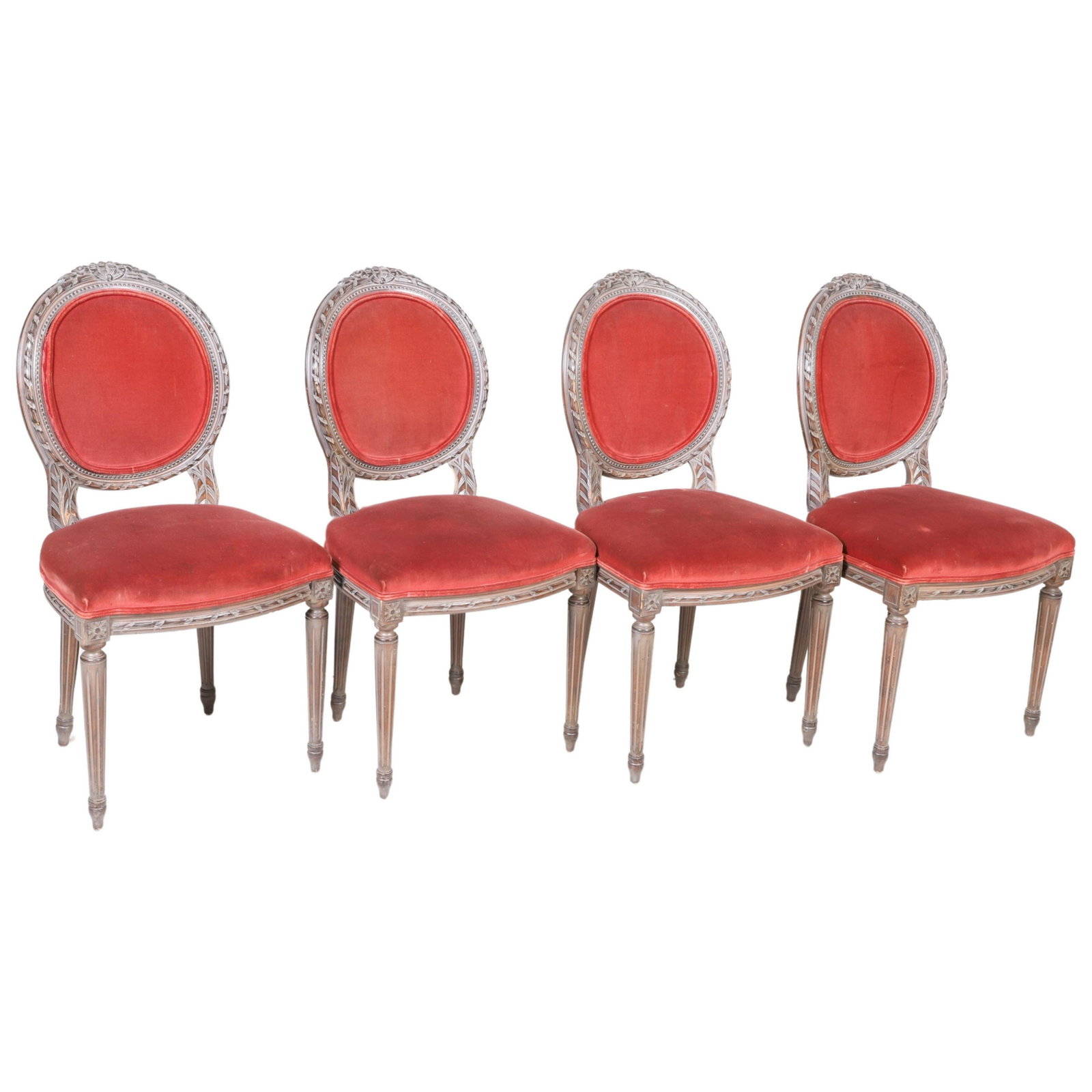 (4) Louis XVI style carved walnut side chairs: (4) Louis XVI style carved walnut side chairs, ribbon carved back with bow at crest, red crushed velvet upholstery, rosettes over reeded tapered legs, 36-1/2"h x 19"w x 18"d, soiling to upholstery