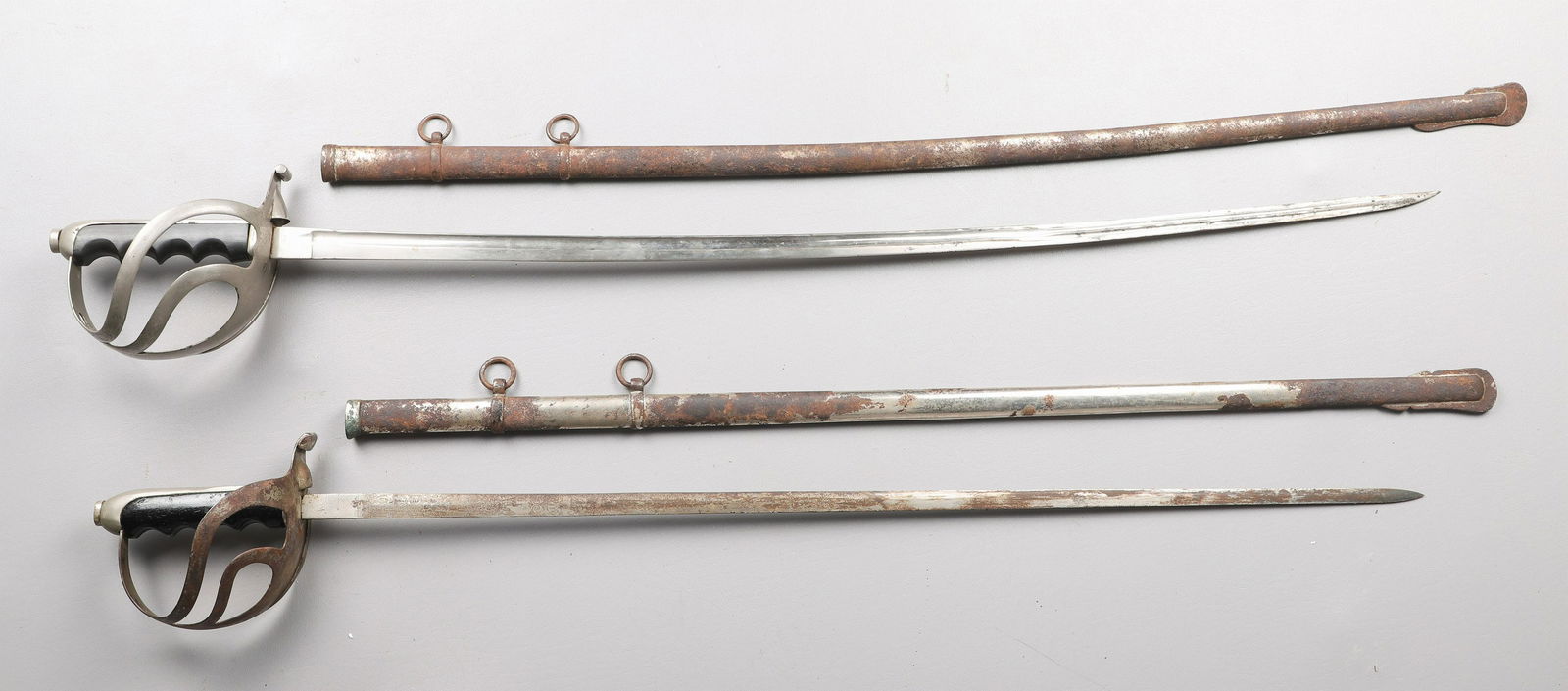 (2) Italian Mid 20th C Military Swords: (2) Italian mid 20th c military swords, one marked as SA Gnutti, solid basket; the other one unmarked with pierced basket, thin blade with military engraving, both with considerable surface distress a