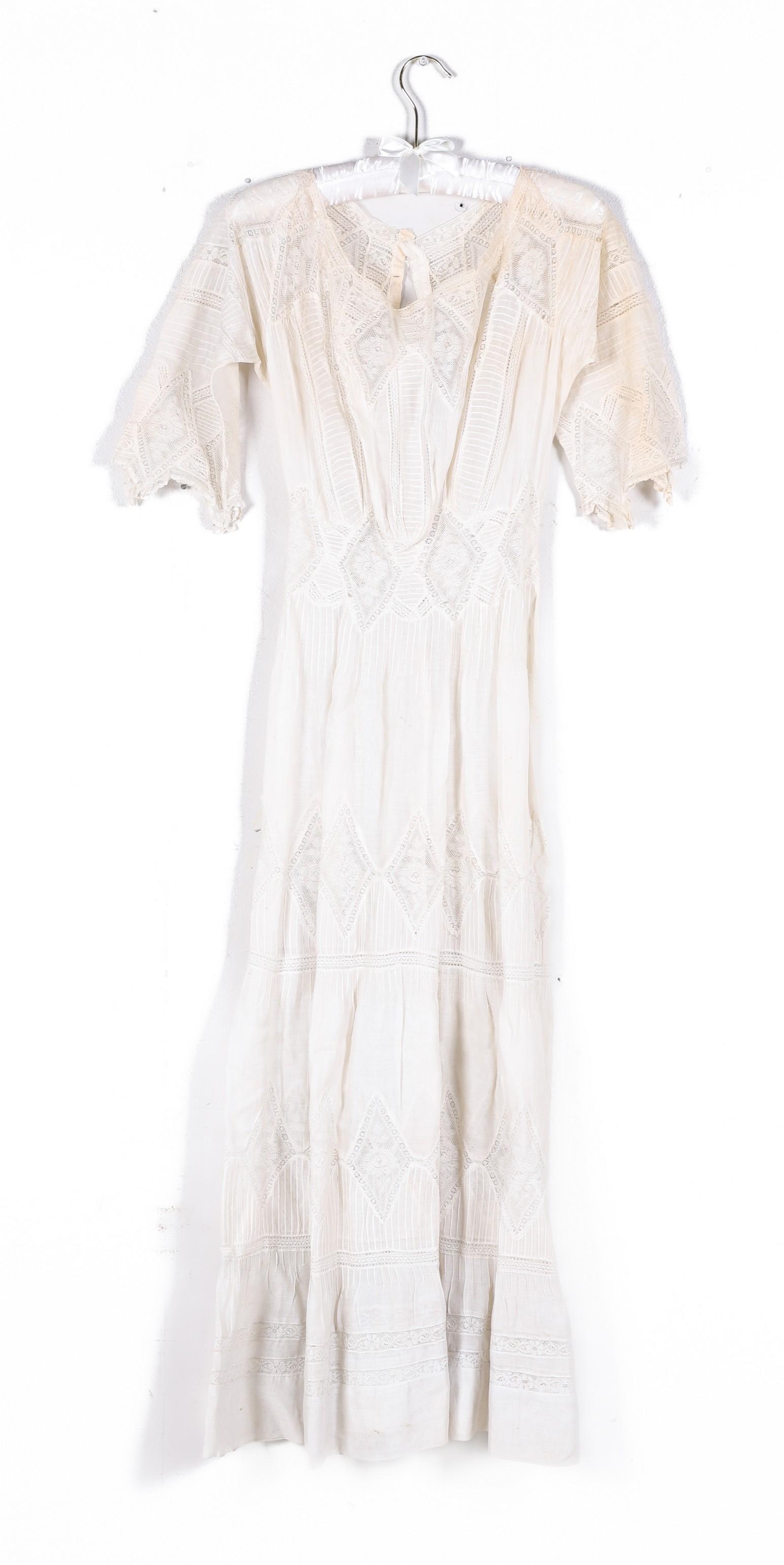 1900 Lace Openwork Dress: 1900 Lace openwork dress, heavily lace inset, rose centered diamond and banded lace, scarf hem sleeves, lace repeating to hem, MOP closure at back, 32" bust, 21" waist, free hips