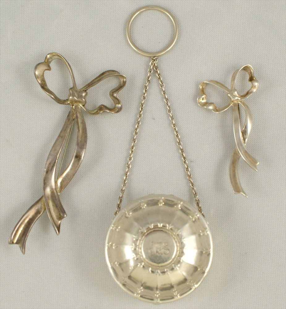 (2) Tiffany & Co sterling silver bow pins with a: (2) Tiffany & Co sterling silver bow pins with a Tiffany & Co pill box on chatelaine chain, 1.99 TO, longest pin 3 1/4"