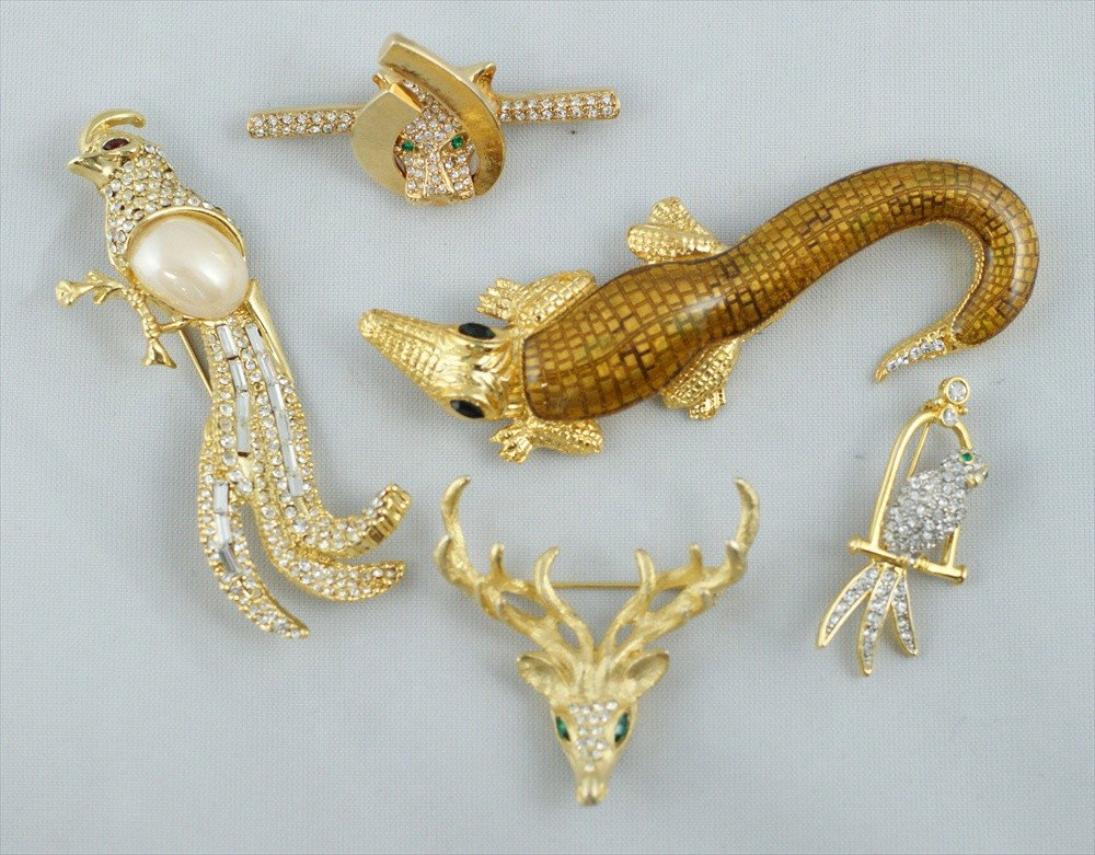 5 piece costume jewelry lot consisting of rhines: 5 piece costume jewelry lot consisting of rhinestone lioness pin, 2" L, signed Radiance, gold tone Stag head with green stone eyes signed, 2" w, gold tone Quail pin with faux pearl and rhinestones, 3"