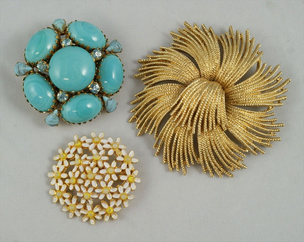 3 piece costume jewelry lot consisting of Monet: 3 piece costume jewelry lot consisting of Monet gold tone spray form brooch, 3"d, Regency blue stone and rhinestone brooch, 2" d, Weiss enamel daisy brooch, 1.5" d
