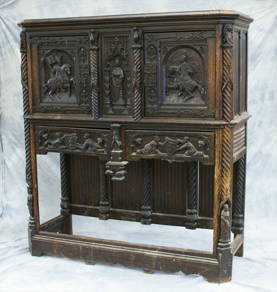 Continental Oak Cabinet On Stand with molded co: Continental Oak Cabinet On Stand with molded cornice over two carved panel doors, center panel with woman standing holding shield flanked by spiral columns with eagles at top, front corners with lions