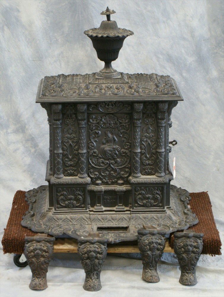 Cast iron parlor stove, Airtight No 1, Viall &: Cast iron parlor stove, Airtight No 1, Viall & Warren, Mechanicville, NY, Saratoga County, front panel depicting King Neptune, legs with lion masks, overall ornate floral design, 37" h, 27" w