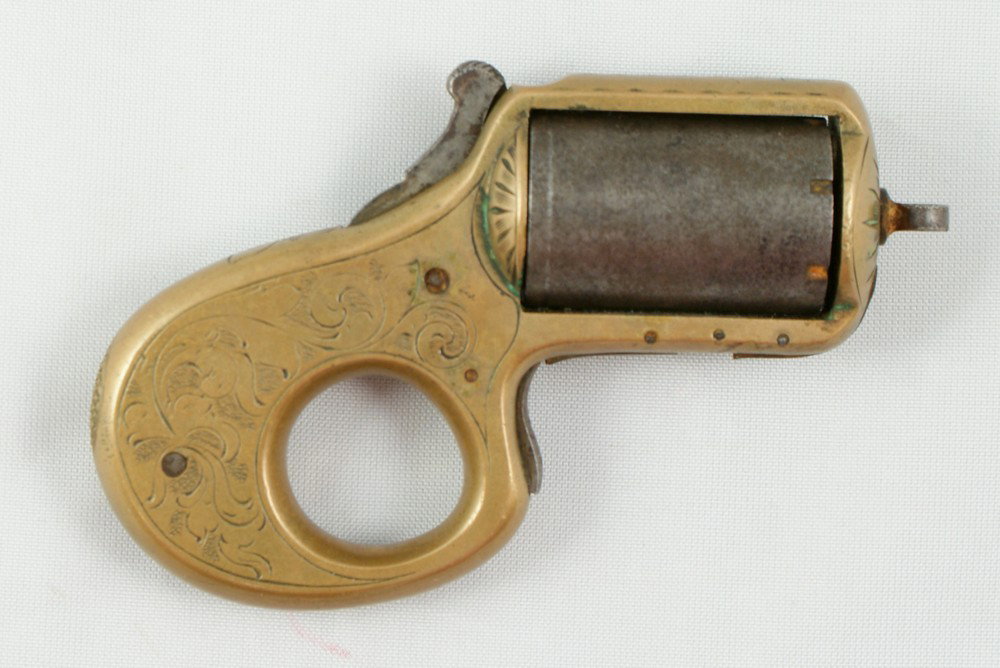 c 1868-1882, 7 shot 22 caliber revolver, constru: c 1868-1882, 7 shot 22 caliber revolver, constructed without a barrel, the cylinder acts as the barrel. The left side of the top strap is marked "MY FRIEND PAT'D DEC 26, 1865". The brass frame is engr