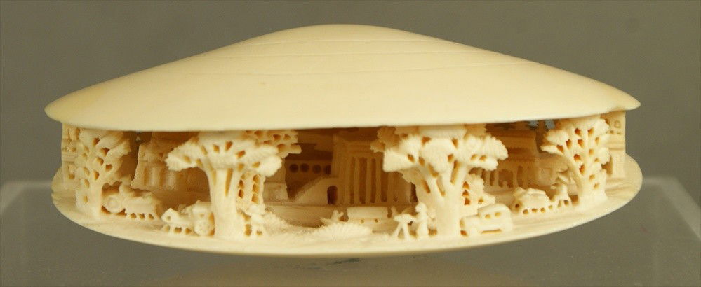 Carved ivory clamshell, cityscape scene with hor: Carved ivory clam shell, cityscape scene with horse drawn carriages & automobile, some roughness at edges of shell, not signed, 4 1/2" long, Sold subject to CITES import/export laws, see Paragraph 12