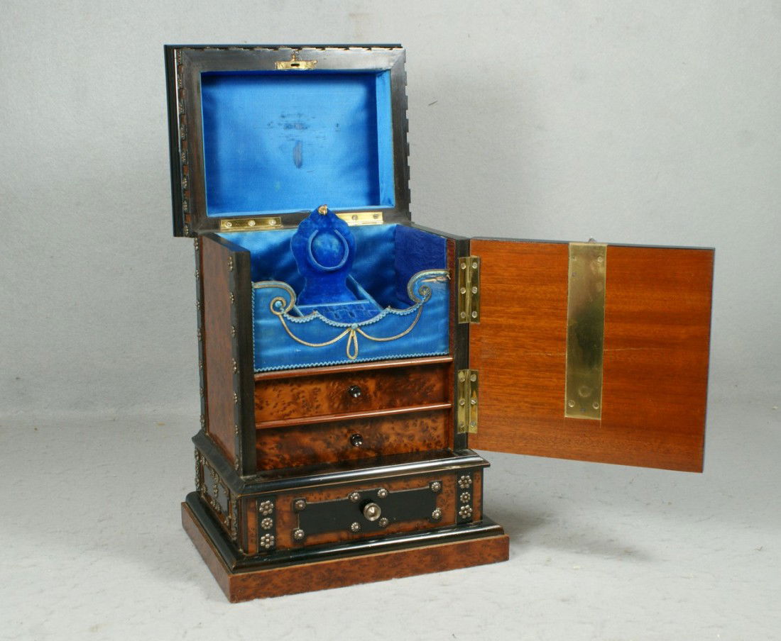 Burl and ebony Continental jewelry box with fitt: Burl and ebony Continental jewelry box with fitted velvet lined interior, watch holder and earring tray, 2 burl front drawers, unusual locking mechanism to open the front. Mounted with silver colored