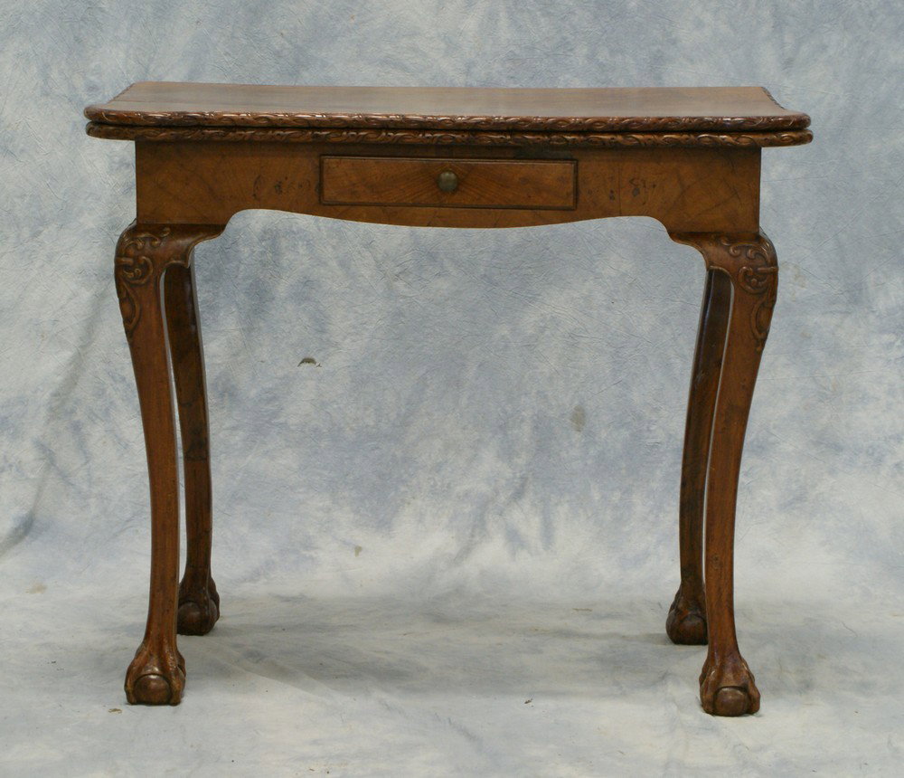 Carved and burl walnut Queen Ann style turret c: Carved and burl walnut Queen Ann style turret corner gaming table, with scooped money pockets, drawer in apron, 19th c