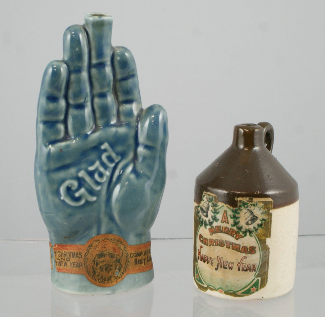 Glad Hand pottery flask with label "Merry Chris: Glad Hand pottery flask with label "Merry Christmas and Happy New Year, Compliments of Harry Kreuze"6" tall, with a tan and brown jug, paper label "Merry Christmas and Happy New Year", 3 1/2" h