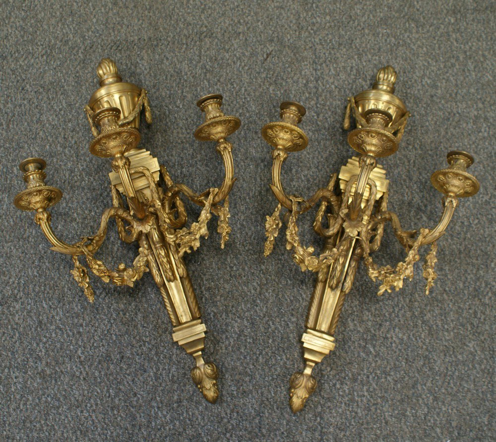 Pr gilt bronze 3 arm wall sconces decorated wit: Pr gilt bronze 3 arm wall sconces decorated with urn finial and floral swags, 31"tall