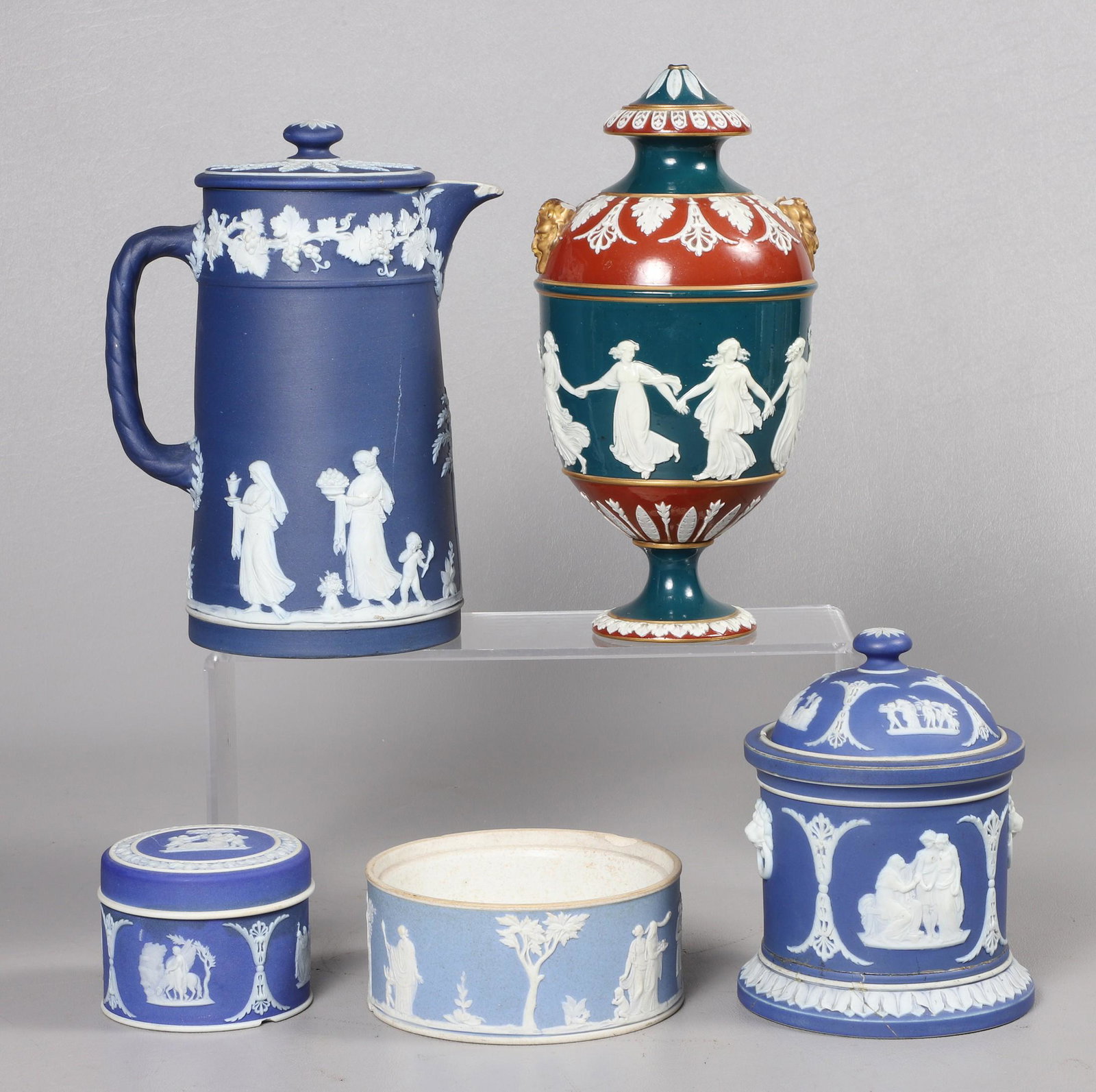 (5) Wedgwood Articles for Repair: (5) Wedgwood articles for repair to include 19th c glazed tri-color covered urn in gilt highlight, lacking handles and finial, 8"H, blue dip chocolate pot, with cracks and losses, 6-1/2"H, blue dip co