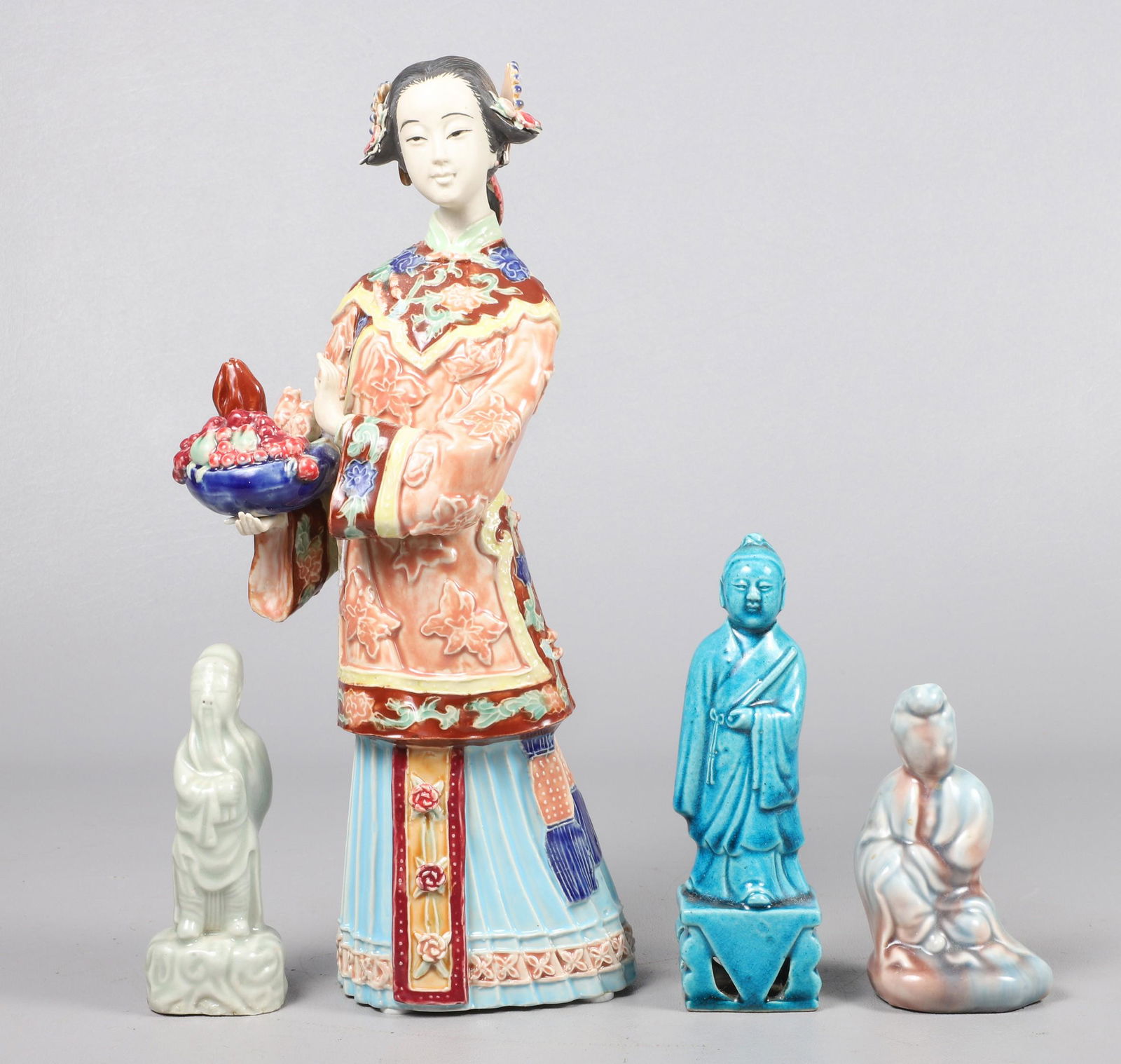 (4) Chinese Porcelain Figures: (4) Chinese porcelain figurines, c/o woman with bowl of fruit marked Ã¢€Å“Made in China" (12" h), turquoise glazed scholar (5-3/4" h), celadon scholar (4-1/2" h), seated woman (4" h)