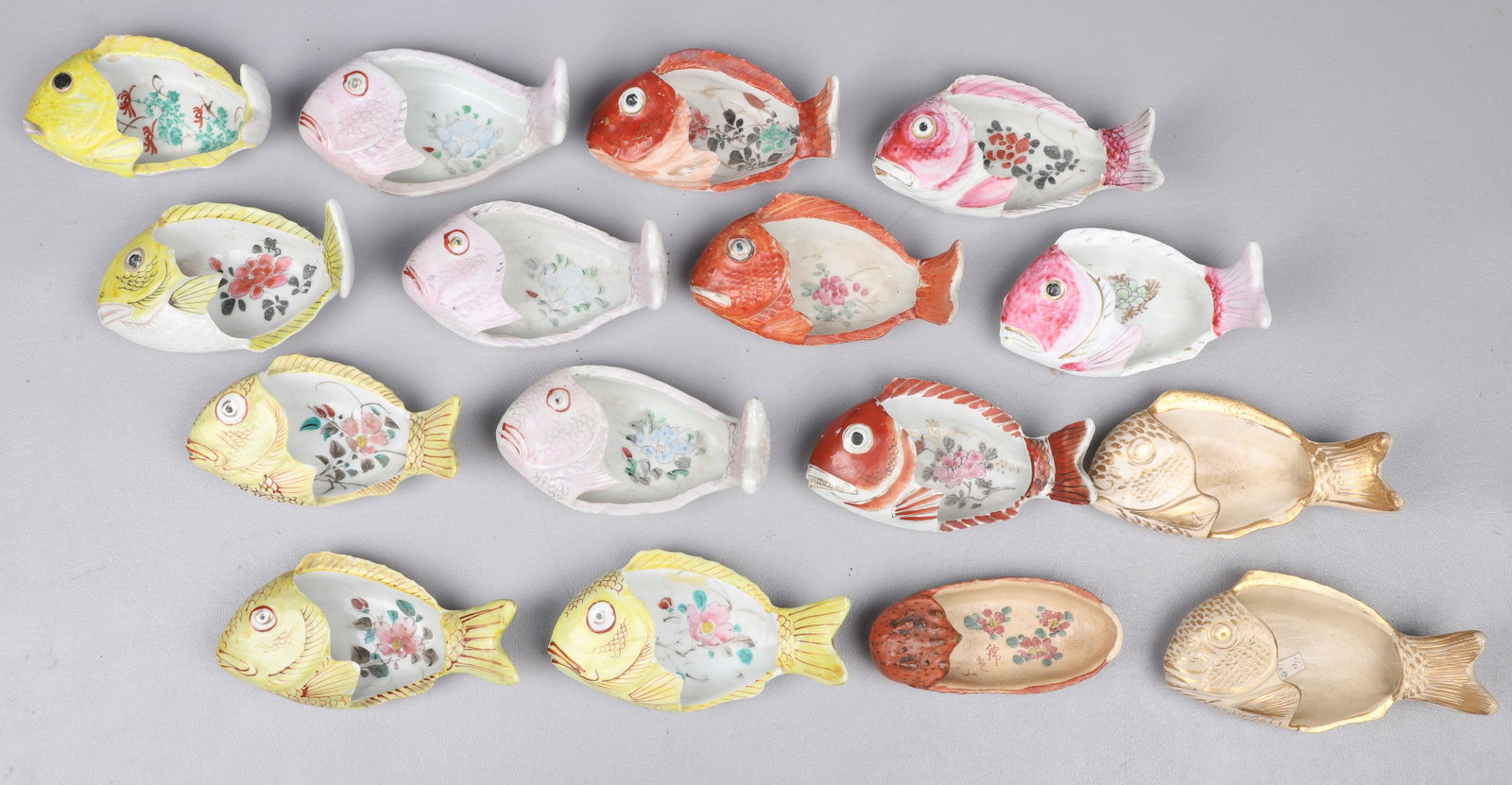 (16) Asian Porcelain Fish Form Bone Dishes: (16) Chinese porcelain fish form bone dishes, yellow, pink & coral, with hand painted flower interiors, some with gilt accents, longest 5-1/2" l, one missing tail