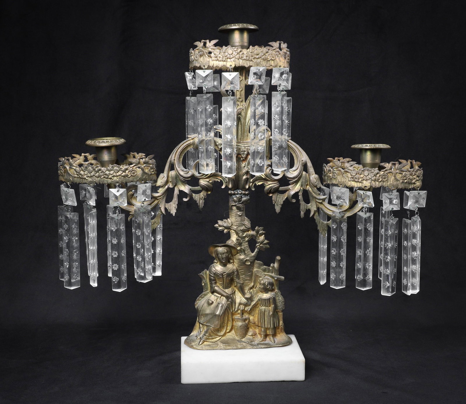 Bronze & Marble Figural Girandole: Bronze and marble figural girandole, gilt bronze woman & young girl with butter churn in relief, 3-light with birds & floral candle cups & prisms, white marble base, 17" h x 18" w