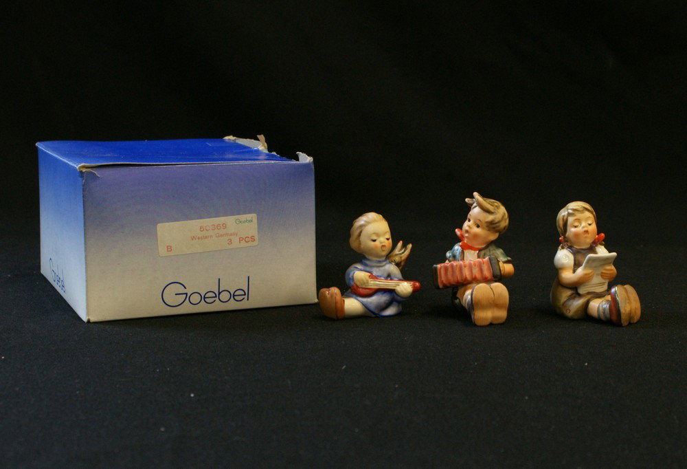 (3) Hummel Figurines, 'Girl with Sheet Music' Hu: (3) Hummel Figurines, 'Girl with Sheet Music' Hum 389, 'Boy with Accordion' Hum 390, 'Angel with Lute' Hum 238 A, tallest 2 5/8", 3-piece set with one box