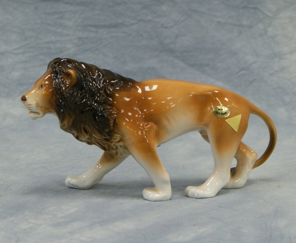 Royal Dux porcelain Lion figurine, two gold seals: Royal Dux porcelain Lion figurine, two gold seals on hind quarters one triangle Royal Dux and one oval "Made in Czech Republic" on bottom R inside circle and pink Royal Dux seal, illegible letters imp