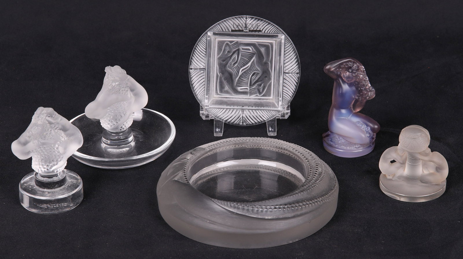 (6) Lalique Crystal Figures and Dishes: (6) Lalique crystal figures and dishes to include Roxane dish and paperweight, 3-3/8"H each, R Lalique ashtray (coupe), Marcilhac No. 293, 1930, with a rim featuring a nude woman swimming through stre