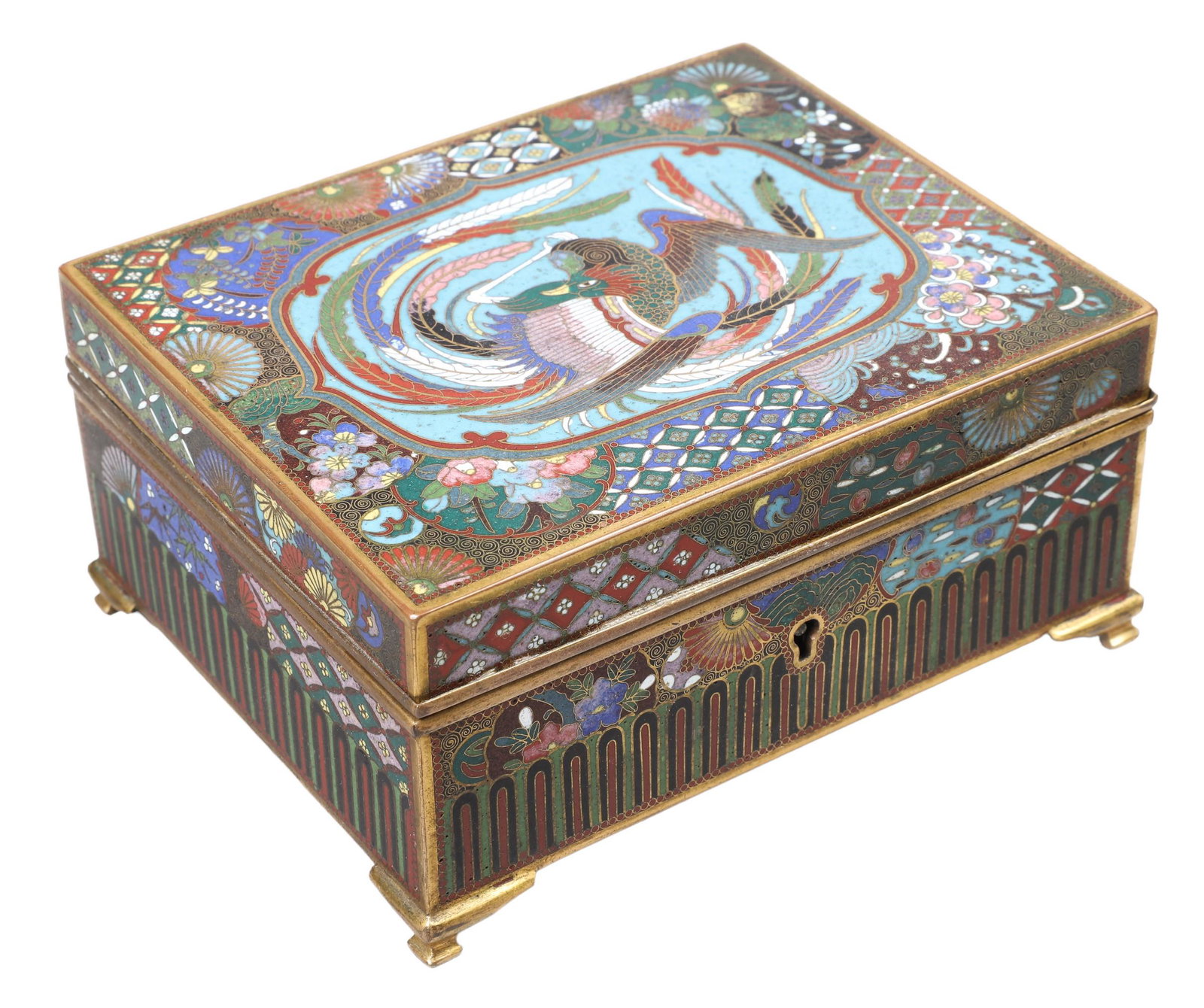 Japanese Meiji Cloisonne Phoenix Box: Japanese Meiji Cloisonne Phoenix Box, intricate multi-pattern enamel inlaid box with brilliant multi-color phoenix in cartouche at lid, geometric surround, on bracket foot, lined in brass with bird an