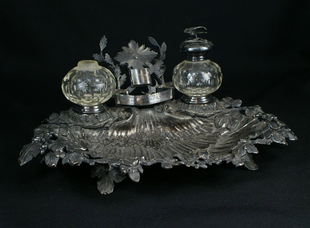 Continental plated silver inkstand, with inscript: Continental plated silver inkstand, with inscription "Bestuurderen van het Asyl Steenbeek aan de Directrice Mej'w P Voute / 1848 23 January 1873", the center crest with various Masonic devices, with 2