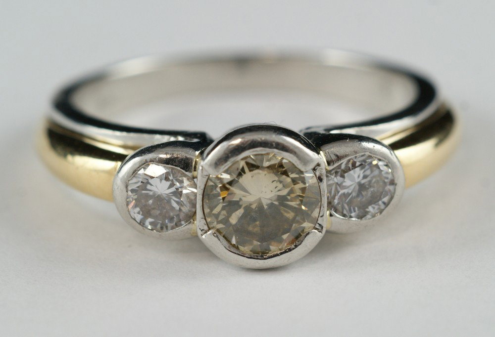 Platinum and 18K YG ladies 3 stone diamond ring, : Platinum and 18K YG ladies 3 stone diamond ring, center a brown diamond, .72 carat, SI-1, C4, flanked by 2 round brilliant diamonds, abour 22-24 pts each, size 8, with a $6000 insurance appraisal