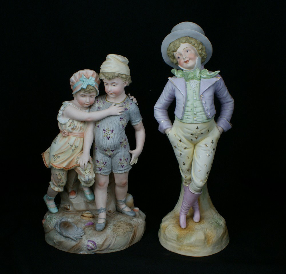 Royal Rudolstat bisque figurine of a young dandy,: Royal Rudolstat bisque figurine of a young dandy, 15 1/2" h, with another unmarked bisque figurine of a boy and girl with a crab and seashells on base, 13 1/4" h, no damage observed